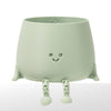 Green robot-shaped planter with a smiley face on a white background